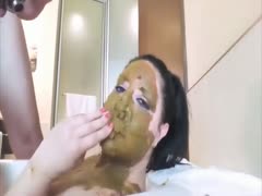 A foreign scat lover is putting crap in a woman's mouth.